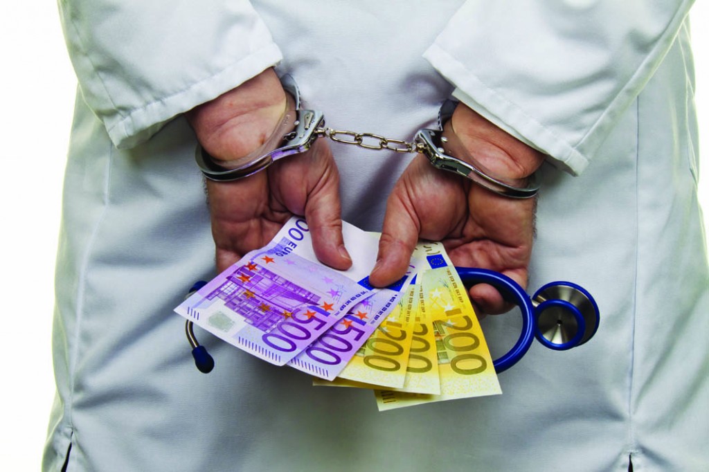 Physician with Euro bank notes and handcuffs